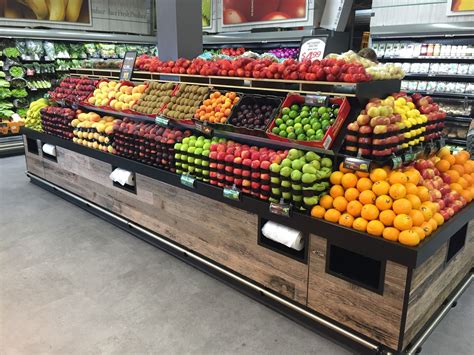 an assortment of fruits and vegetables on display in a grocery store