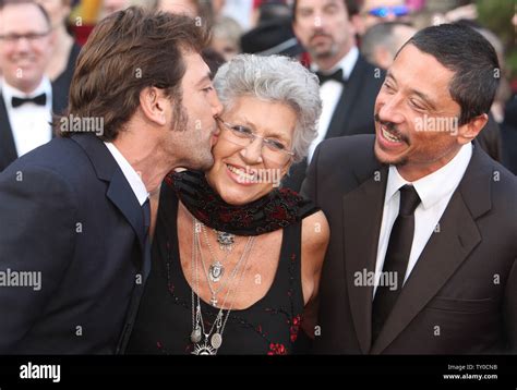 Spanish actor Javier Bardem (L) kisses his mother Pilar as his brother ...