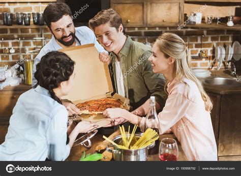 Young people eating pizza — Stock Photo © ArturVerkhovetskiy #150956792