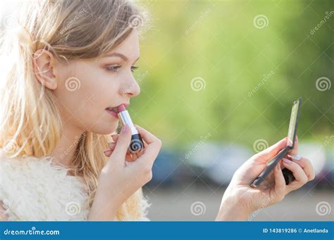 Woman Applying Red Lipstick Stock Photo - Image of close, face: 143819286