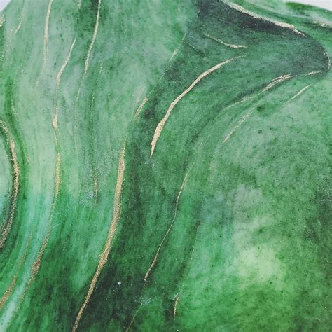 an abstract painting with green and gold streaks on it's surface is ...