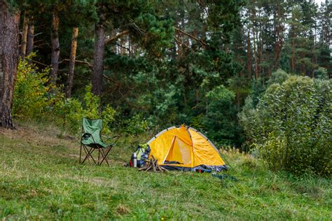 camping with tent and campfire and kayaks