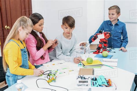 Focused children working together on stem project in classroom - Stock Photo - Dissolve