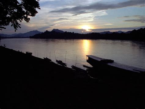 Sunset over the Mekong river with fishing and transport boats in the foreground. | Smithsonian ...