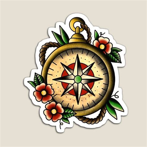 an old school compass tattoo design with flowers