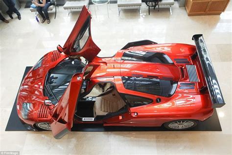 a red sports car is on display in a building