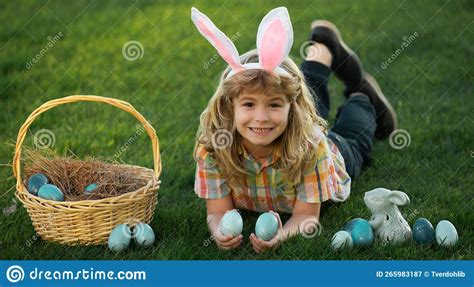 Bunny Kids with Rabbit Bunny Ears. Child Hunting Easter Eggs in Backyard Laying on Green Grass ...