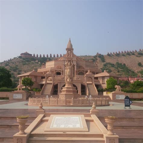 a statue in front of a large building