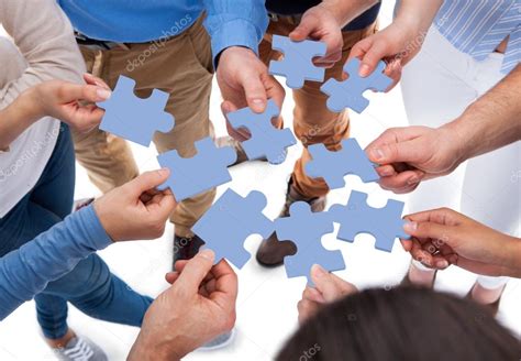 Group of people connecting puzzle pieces — Stock Photo © AndreyPopov #43675059