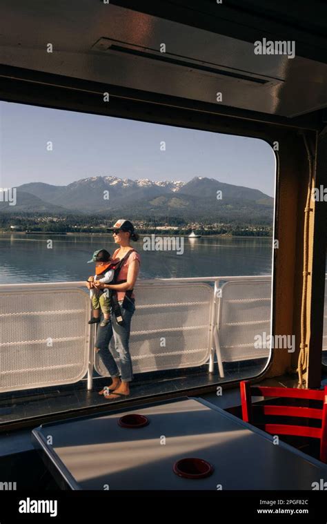 A mother carries her child on a ferry in Strait of Juan de Fuca Stock ...