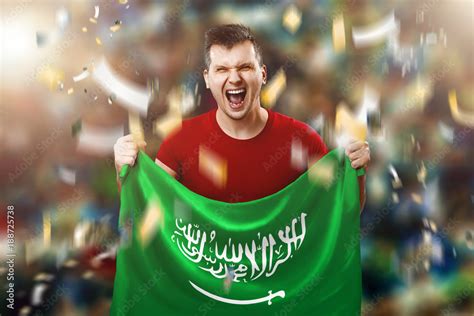 Saudi Arabia is a fan, a fan of a man holding the national flag of ...