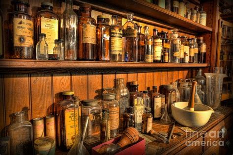 an old pharmacy cabinet filled with lots of medicine bottles and mortars on top of it