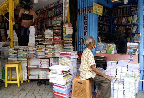 Customers purchase books from book stalls at College street Book market ...