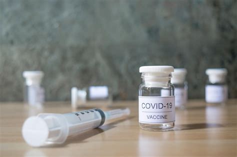 Premium Photo | Syringe and vaccine for covid-19 coronavirus contained in a small bottle