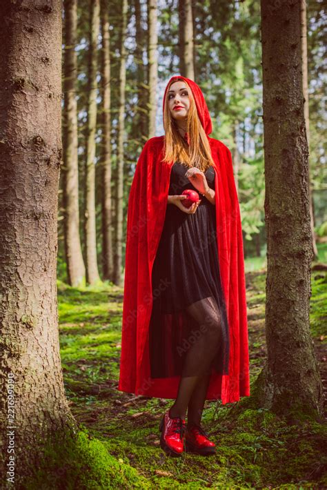 Concept of Halloween. Beautiful and simple costume of little red hood. Mysterious hooded figure ...