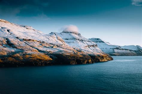 Premium Photo | Snowy peaks in faroe islands