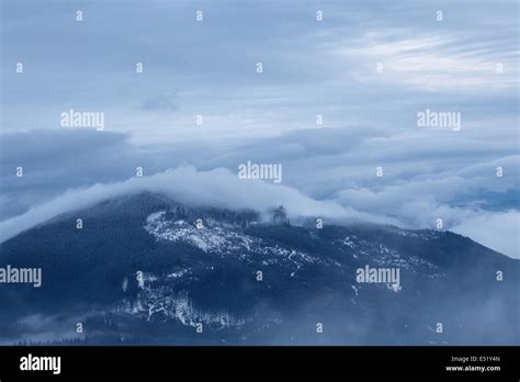 Cloudy mountain landscape Stock Photo - Alamy