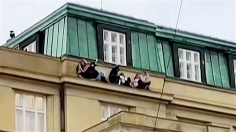 Prague shooting: Footage shows people cowering on ledge of university ...