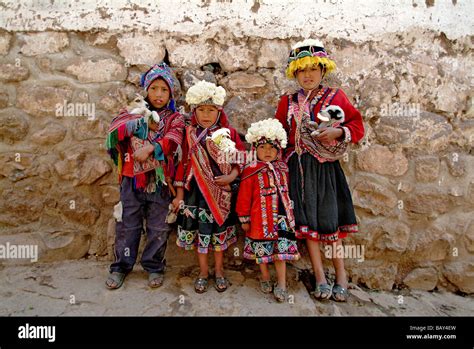 Inca children carrying pets in Pisac, Peru, South America Stock Photo ...