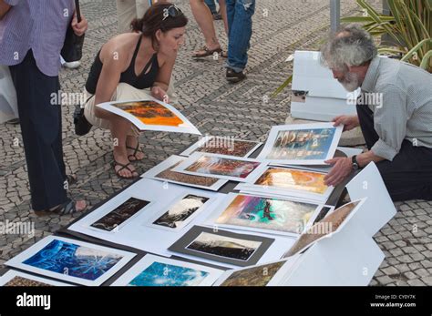 Man selling art works on the street in Lisbon, Portugal Stock Photo - Alamy