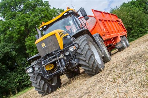 Modern Jcb Tractor Pulling Orange Trailer Editorial Photography - Image of agriculture, blue ...