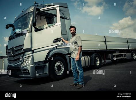 Truck driver with tractor trailer truck Stock Photo - Alamy