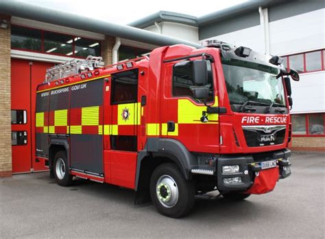 a red fire truck parked in front of a building