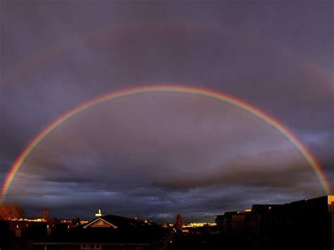 DOUBLE RAINBOW, sun, town, backlight, dark sky, HD wallpaper | Peakpx