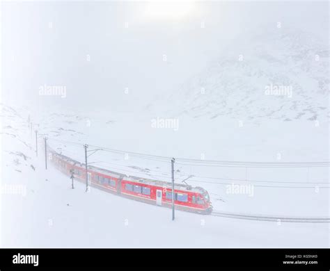 Bernina express train at bernina pass during a snowstorm hi-res stock ...