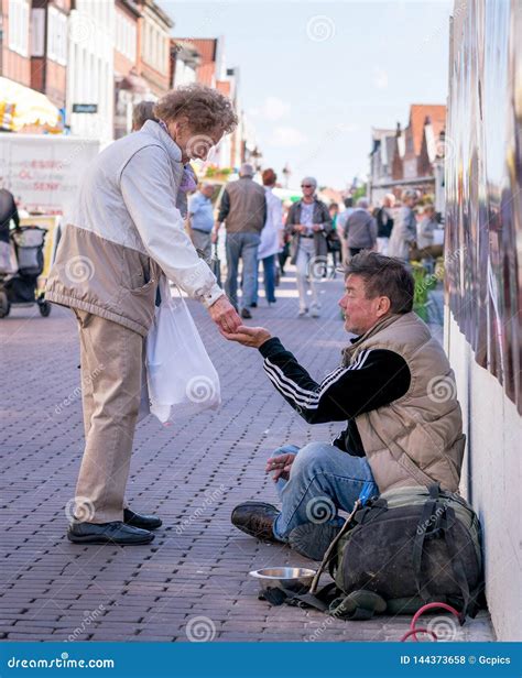 A Lady Giving Money To Homeless Man. Editorial Stock Photo - Image of charity, homeless: 144373658