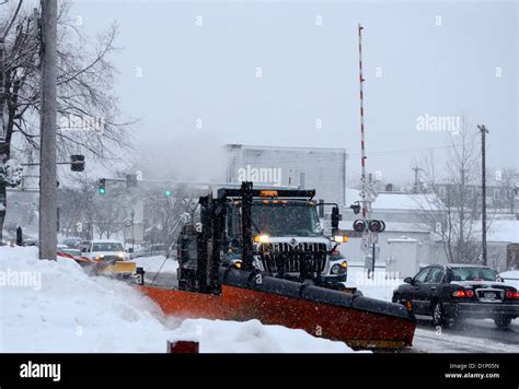 Snow plow clearing Main street in upstate New York town Stock Photo - Alamy