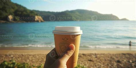 AI generated A Person Hand Holding a Paper Coffee Cup with Beach View ...