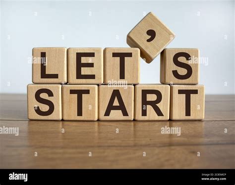 Concept word 'lets start' on cubes on a beautiful wooden background ...