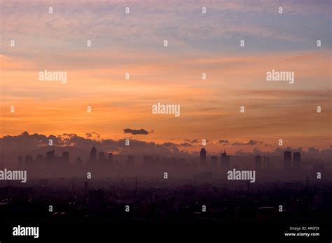 The skyline of Makati City Manila at sunrise shrouded in mist and fog ...