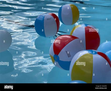 A closeup of beach balls in a swimming pool Stock Photo - Alamy