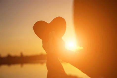 hands forming a heart shape with sunset silhouette 7963618 Stock Photo at Vecteezy