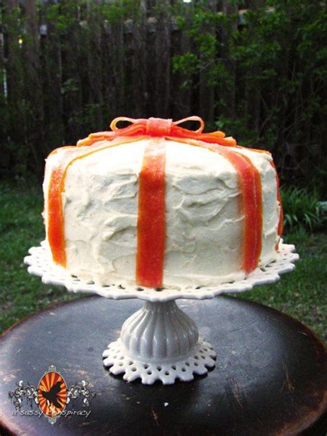 Four layer carrot cake with orange, ginger, cream cheese frosting and candied carrot ribbons ...