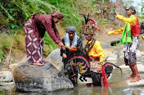 Premium Photo | Several people are carrying out the ritual of bathing kuda lumping in the river