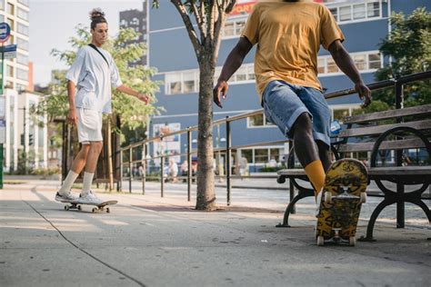 Friends riding skateboards on street in sunny day · Free Stock Photo