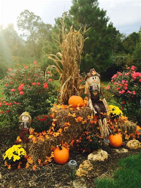 Fall display at driveway entrance with mums, pumpkins, corn stalks, hay ...