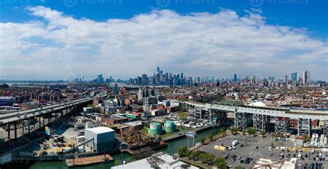 Panoramic view of the Gowanus Canal in Brooklyn with the Gowanus Expressway and Manhattan in the ...