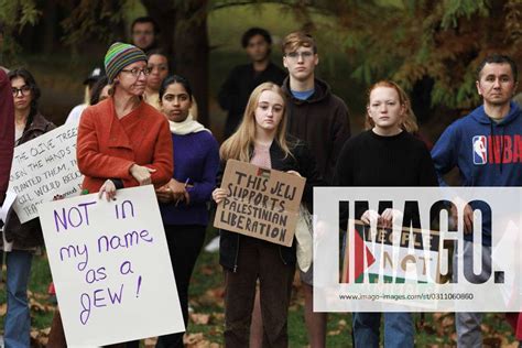 Protest against Israeli ground operations in Bloomington, US - 28 Oct 2023 Protesters hold placards