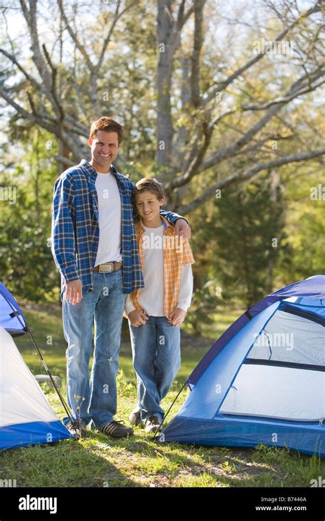 Father and son on camping trip standing beside tents Stock Photo - Alamy