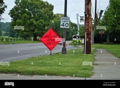 One lane road ahead construction sign on the side of a five lane road Stock Photo - Alamy