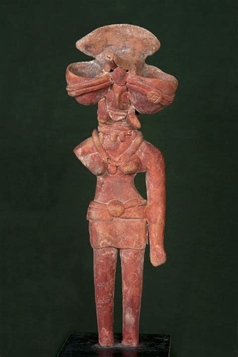 an ancient statue is displayed on a black stand