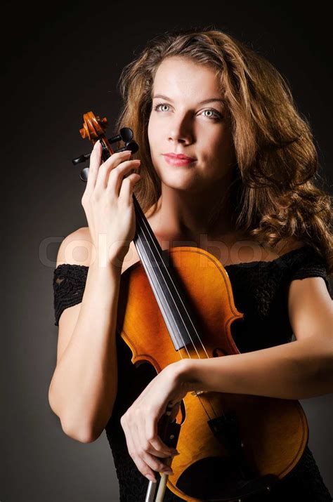 Woman performer with violin in studio | Stock image | Colourbox