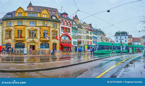 The Rainy Weather on Barfusserplatz of Basel with Riding Trams and Historic Townhouses in ...