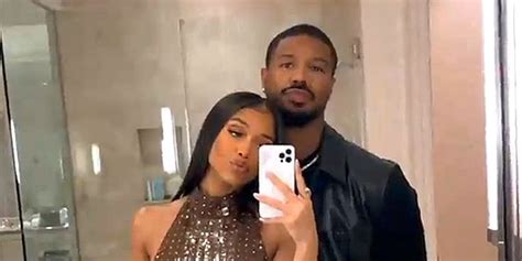 a man and woman taking a selfie in the bathroom