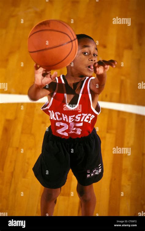 Young African American boy shooting a basket Stock Photo - Alamy