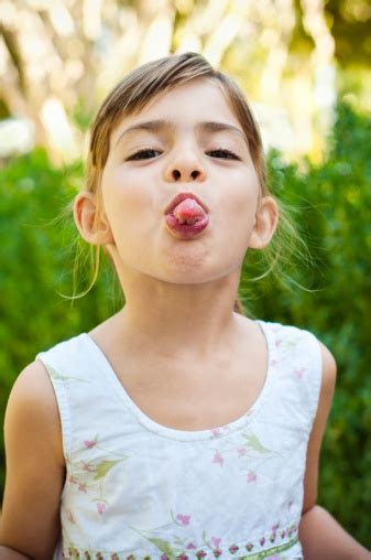 Girl Sticking Her Tongue Out Stock Photo - Download Image Now - iStock